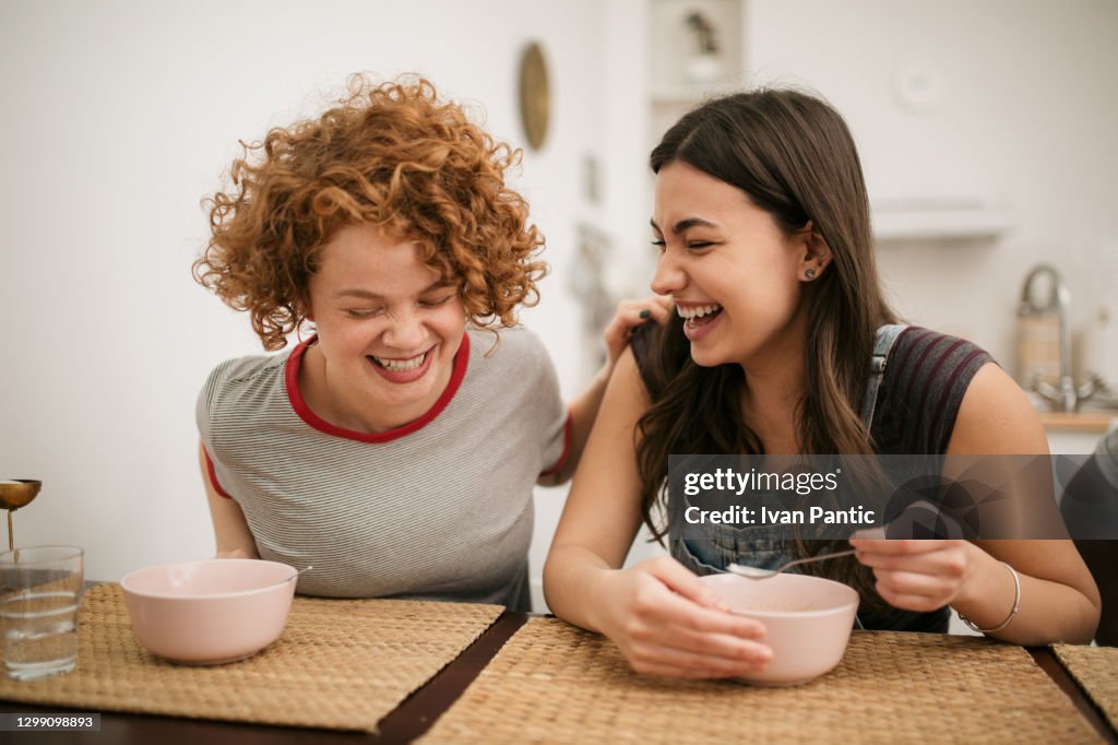 Two Caucasian female having a meal at home