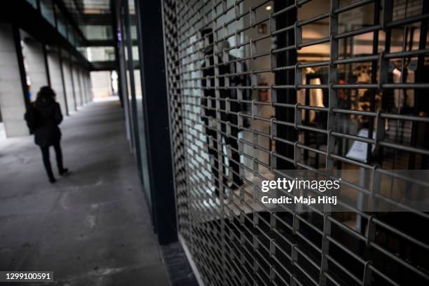 Woman walks past a closed luxury shop during the second wave of the coronavirus pandemic on January 28, 2021 in Berlin, Germany. The German...