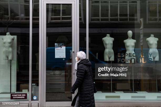 Woman walks past a closed luxury shop during the second wave of the coronavirus pandemic on January 28, 2021 in Berlin, Germany. The German...