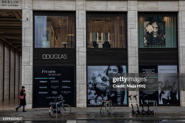 Woman walks past a closed Douglas perfumery chain during the second wave of the coronavirus pandemic on January 28, 2021 in Berlin, Germany. Due to...