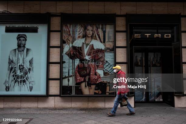 Man walks past a closed luxury shop during the second wave of the coronavirus pandemic on January 28, 2021 in Berlin, Germany. The German government...