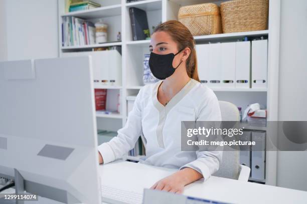 beautiful woman in uniform performing administrative tasks - chief administration office foto e immagini stock