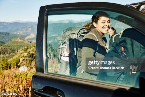 laughing young woman preparing for backpacking trip with sisters - travel16 stock pictures, royalty-free photos & images