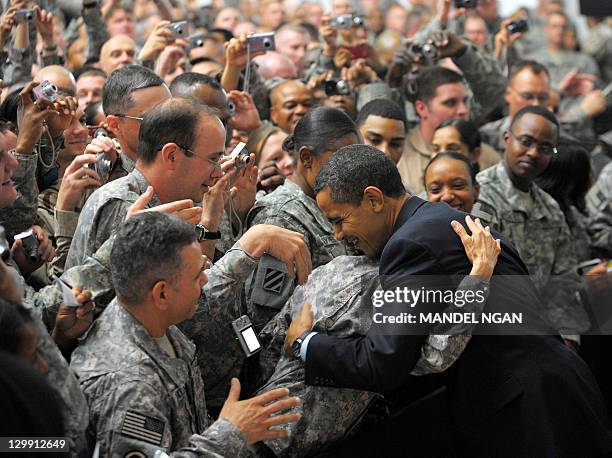 President Barack Obama greets troops during a visit to Camp Victory, just outside Baghdad, on April 7, 2009. - US President Barack Obama planned to...