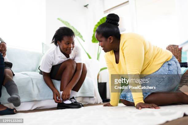 daughter fitting new school shoes at home - parent daughter school uniform stock pictures, royalty-free photos & images