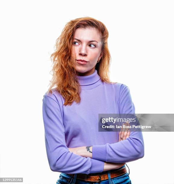 young woman with arms crossed, annoyed - gereiztheit stock-fotos und bilder