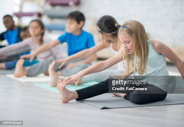 warming up before yoga class - hot yoga stock pictures, royalty-free photos & images