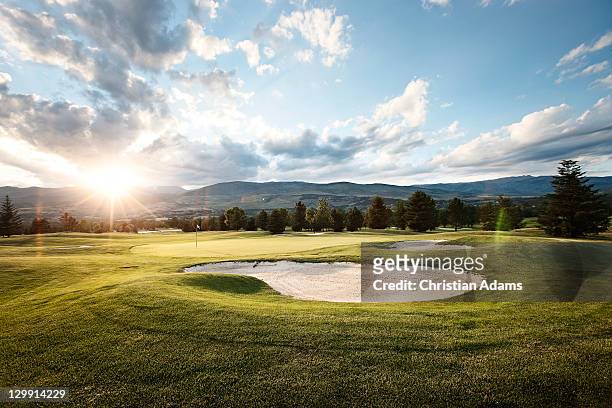 golf at sunset - golf course stock pictures, royalty-free photos & images