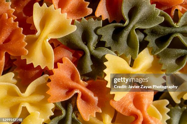 dry bow tie pasta - bow tie pasta stock pictures, royalty-free photos & images