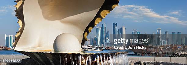 pearl monument and skyline. - doha pearl stock pictures, royalty-free photos & images