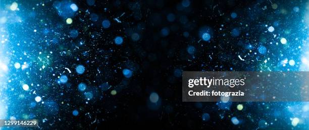 blue bokeh and dust background - snowfall and lights night defocussed stock pictures, royalty-free photos & images