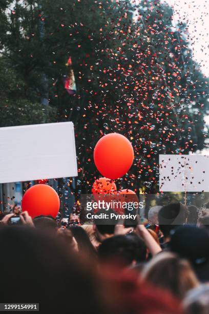 crowd, balloons and confetti - parade balloon stock pictures, royalty-free photos & images