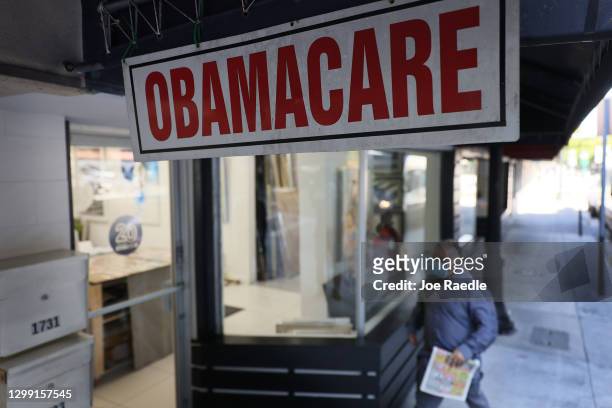 Pedestrian walks past the Leading Insurance Agency, which offers plans under the Affordable Care Act on January 28, 2021 in Miami, Florida. President...