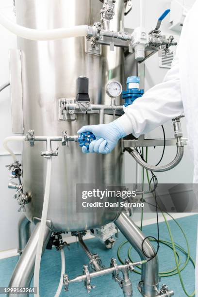 crop worker using fermenter at factory - fermentation tank stock pictures, royalty-free photos & images