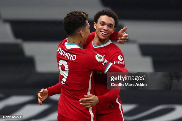 Trent Alexander-Arnold of Liverpool celebrates with teammate Roberto Firminho after scoring his team's second goal during the Premier League match...