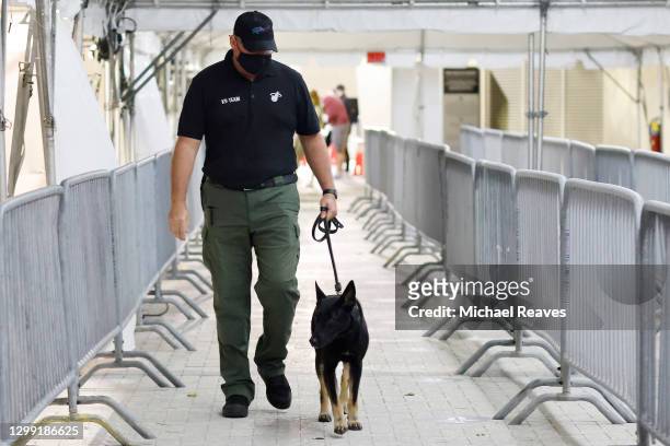 Miami Heat K-9 handler Wayne Weseman walks Happy, a COVID-19 detection dog, prior to the game between the Miami Heat and the Los Angeles Clippers at...