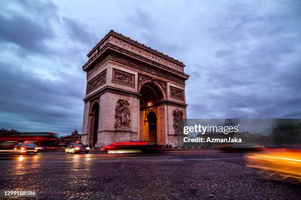 arc de triomphe at dusk - triumphal arch stock pictures, royalty-free photos & images