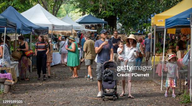 part of the crowd enjoying the 40th anniversary bellingen markets. - community australia stock pictures, royalty-free photos & images