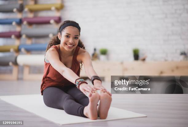 stretching before yoga - yoga teen stock pictures, royalty-free photos & images