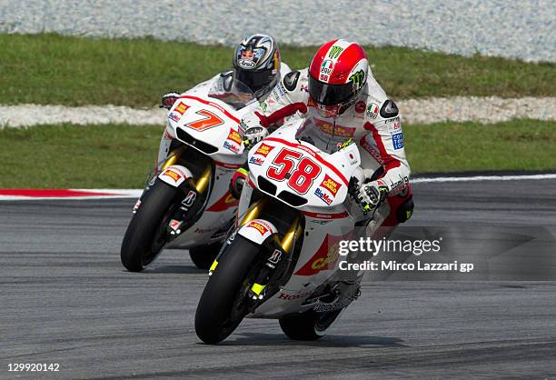 Marco Simoncelli of Italy and San Carlo Honda Gresini leads Hiroshi Aoyama of Japan and San Carlo Honda Gresini during the qualifying practice of...