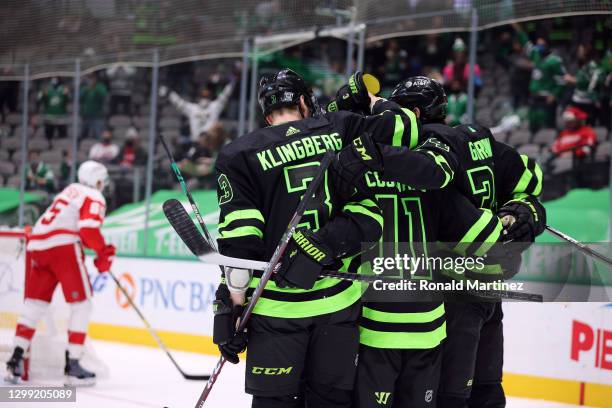 John Klingberg, Andrew Cogliano and Denis Gurianov of the Dallas Stars celebrate a goal against the Detroit Red Wings in the second period at...