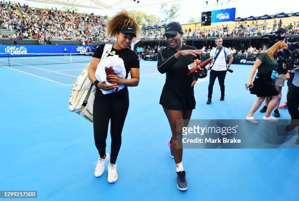 Naomi Osaka of Japan and Serena Williams of the USA leave the court after their match during the 'A Day at the Drive' exhibition tournament at...