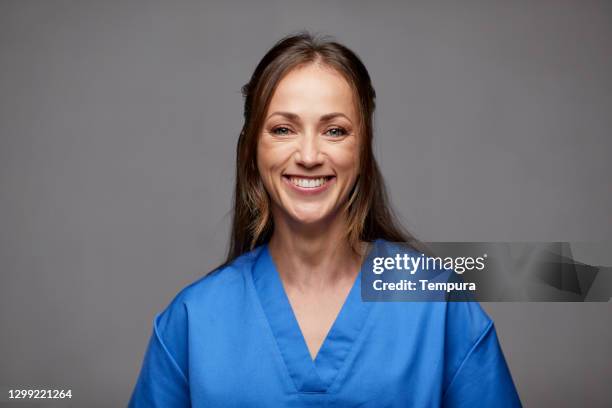 nurse in blue medical scrubs  headshot - doctor headshot stock pictures, royalty-free photos & images