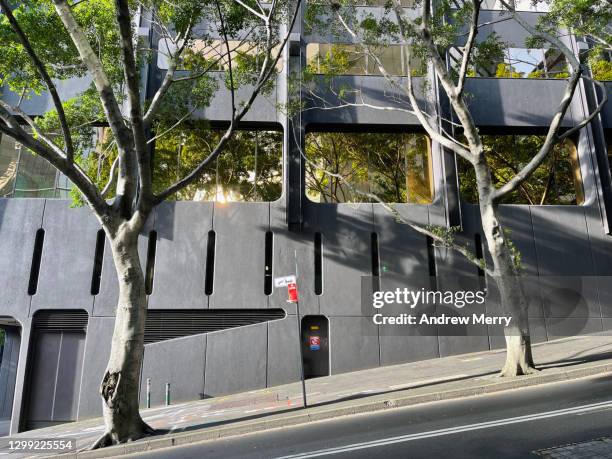 steep city street with footpath, trees, office building and no traffic - uphill stock pictures, royalty-free photos & images
