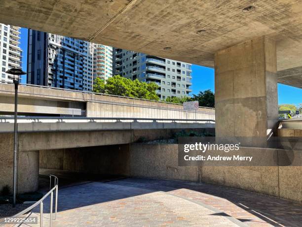 urban landscape with buildings, overpass and pedestrian tunnel walkway, no people - underpass stock pictures, royalty-free photos & images