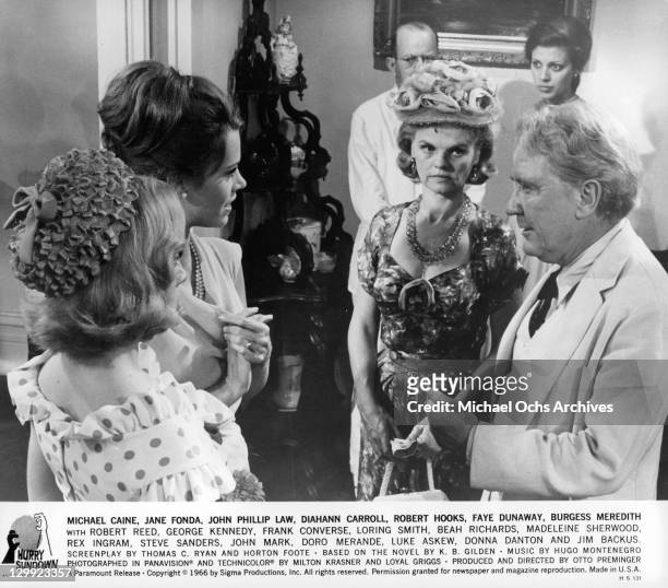 Donna Danton, Jane Fonda, Burgess Meredith and Madeleine Sherwood stand in a circle talking in a scene from the film 'Hurry Sundown', 1966.