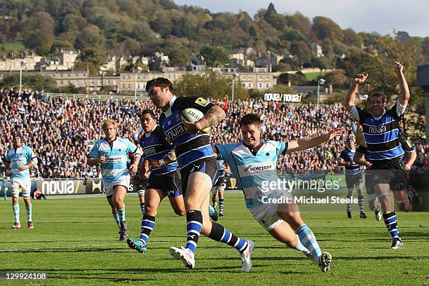 Matt Banahan of Bath scores a try despite the efforts of Ollie Hayes of Worcester Warriors during the LV Cup match between Bath and Worcester...