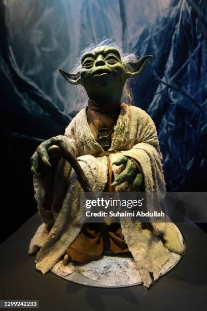 Puppet of iconic character, Yoda sits at a display showcase at The Star Wars Identities exhibition during a media preview at The ArtScience Museum on...