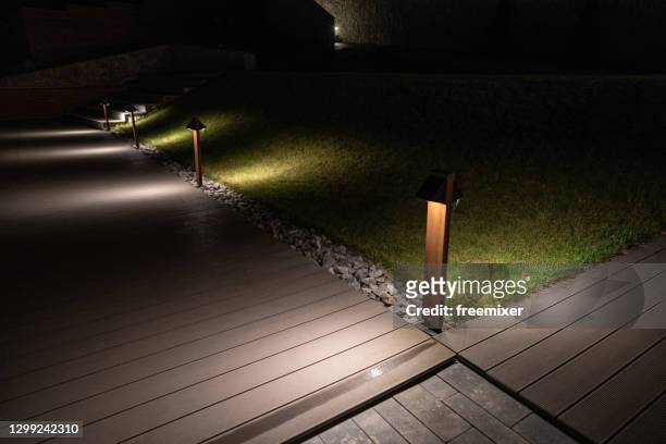 wooden boardwalk illuminated with led lights - led lighting stock pictures, royalty-free photos & images