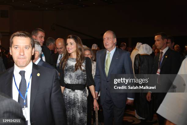 King Juan Carlos of Spain walks with Queen Rania of Jordan during his participation at the World Economic Forum special meeting on economic growth...