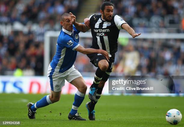 Jonas Gutierrez of Newcastle United in action with David Jones of Wigan Athletic during the Barclays Premier League match between Newcastle United...