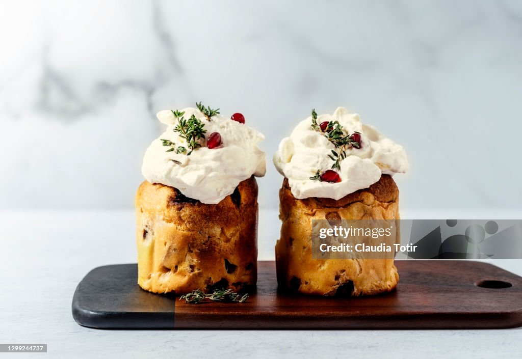 Mini Panettone on cutting board on white background
