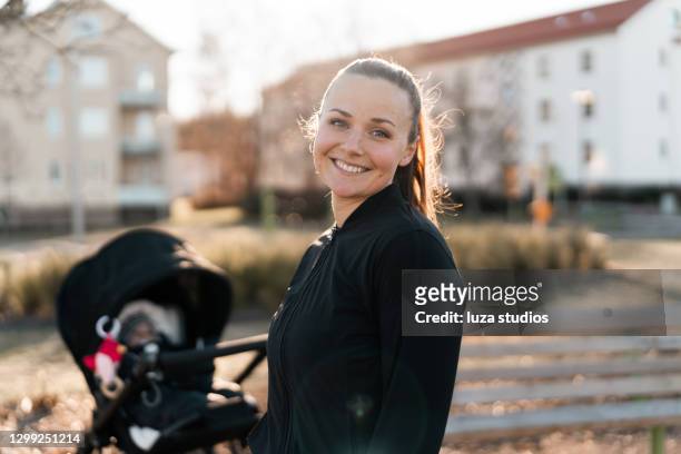 portrait of woman with baby carriage exercising outdoors - scandinavia stock pictures, royalty-free photos & images