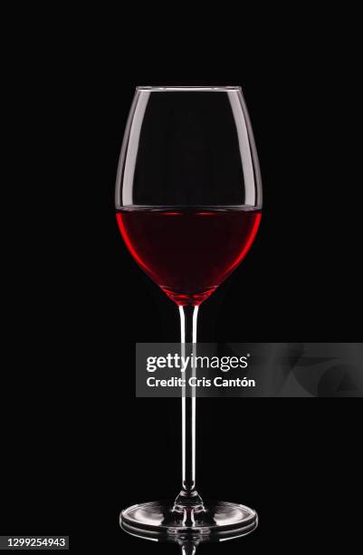 glass of red wine on black background - red wine glass stock pictures, royalty-free photos & images