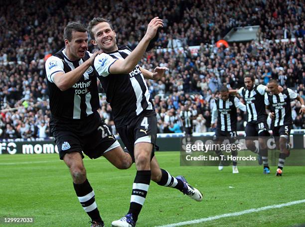 Yohan Cabaye of Newcastle United celebrates with team-mate Steven Taylor after scoring the 1-0 goal during the Barclays Premier League match between...