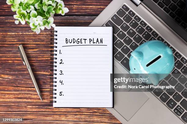 budget plan text on note pad - budget stockfoto's en -beelden