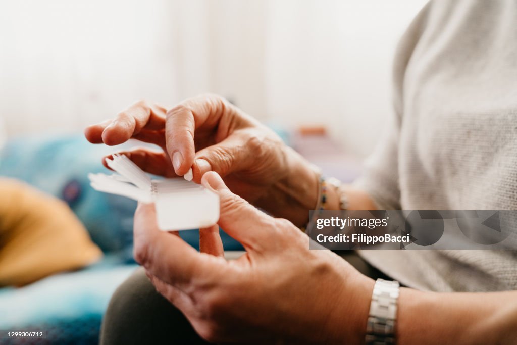 Close up shot a mature woman taking and organizing medicines