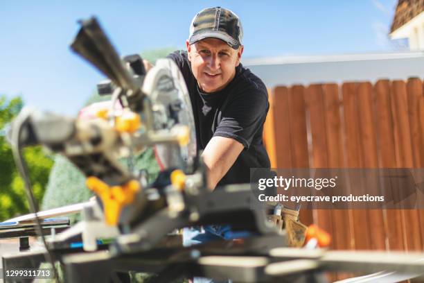 mitre trim saw used by mature adult male working on home remodel project photo series - public housing stock pictures, royalty-free photos & images