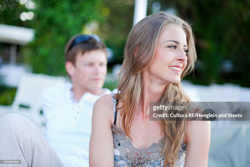 Smiling woman sitting outdoors
