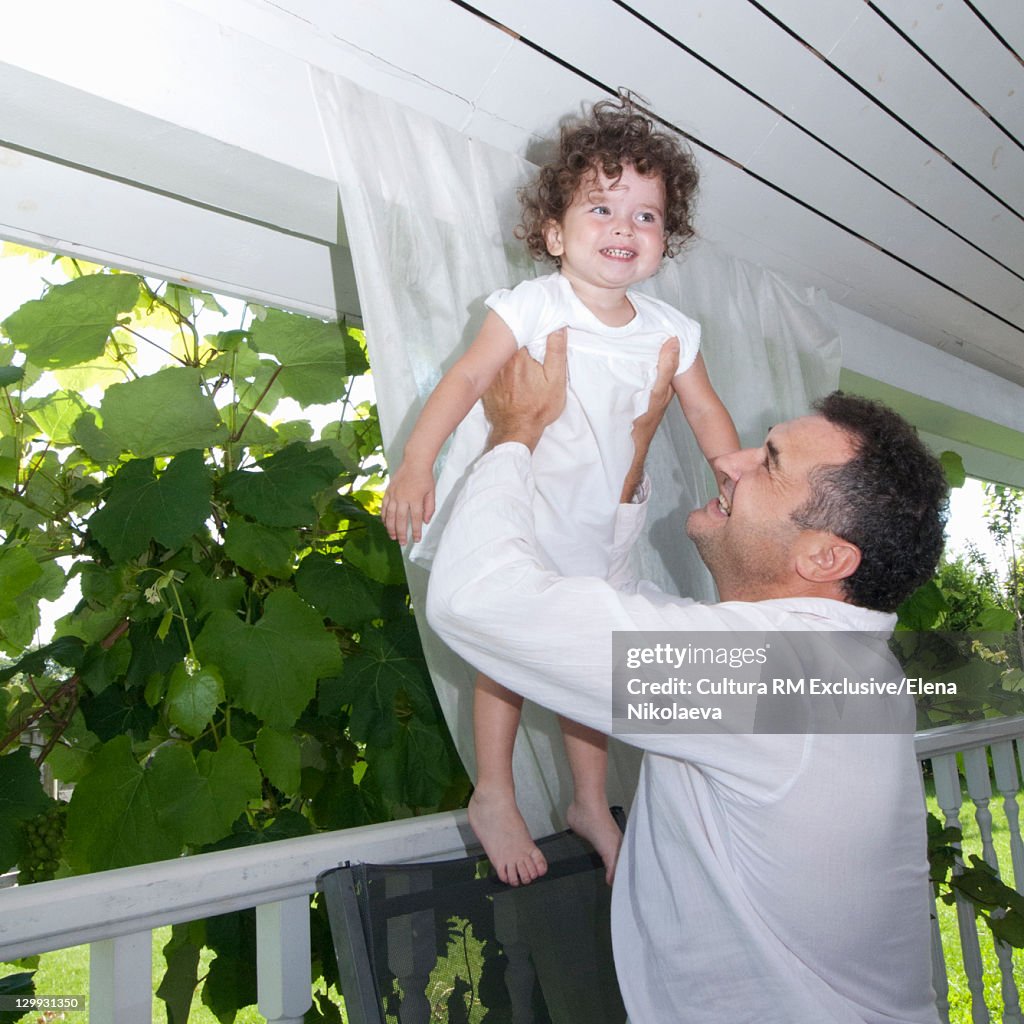 Father swinging daughter in air