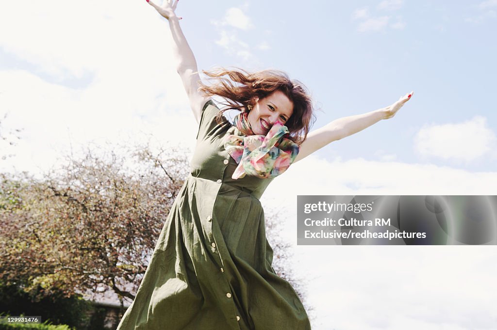 Woman jumping for joy outdoors