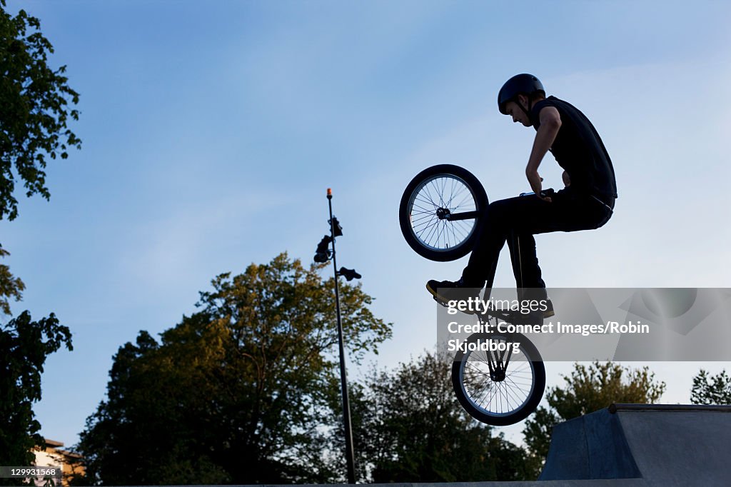 Teenager doing tricks on bmx bike