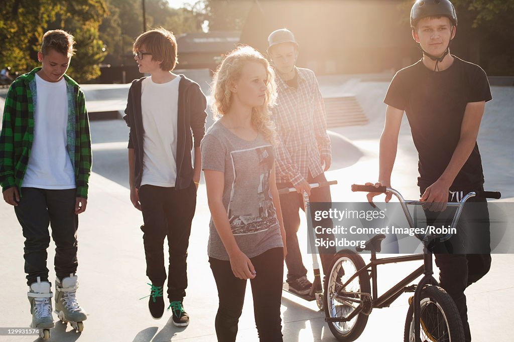 Teenagers walking at skate park