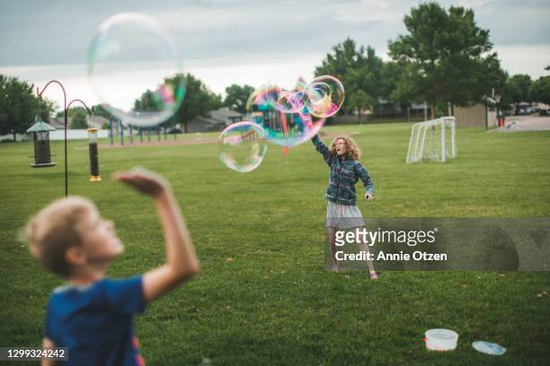 kids playing with big bubbles - big bubble stock-fotos und bilder