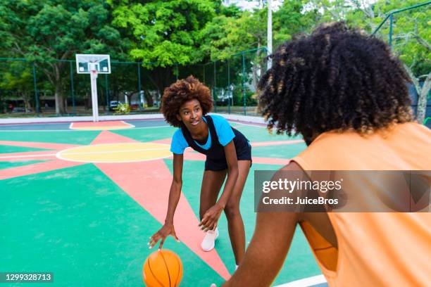 two young athletes play basket 1 on 1 - basketball blocking shot stock pictures, royalty-free photos & images