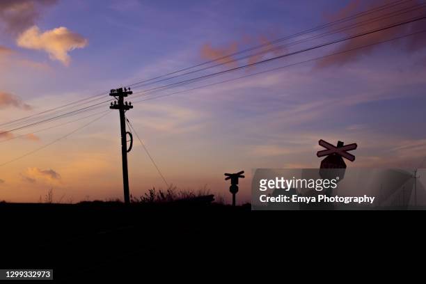 sunset on the road in the countryside in romania - red car wire stock pictures, royalty-free photos & images